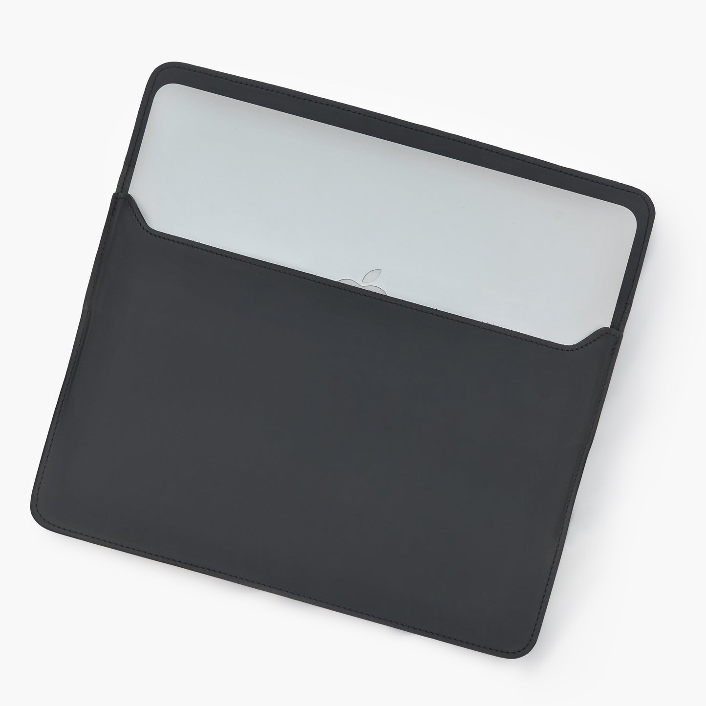 Black Crazy Horse leather MacBook sleeve with partially inserted silver MacBook