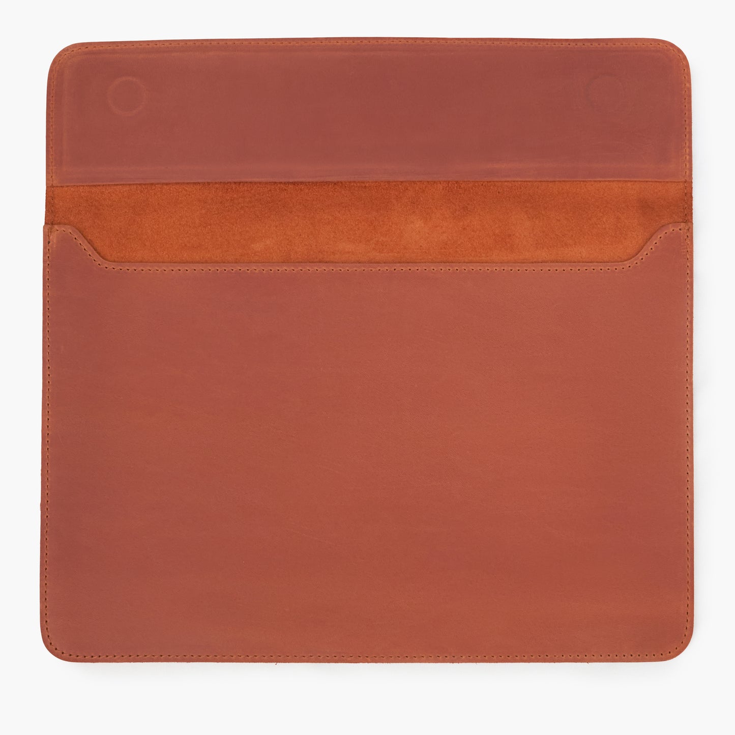 Open cognac Crazy Horse leather MacBook sleeve showing suede interior and magnetic closure