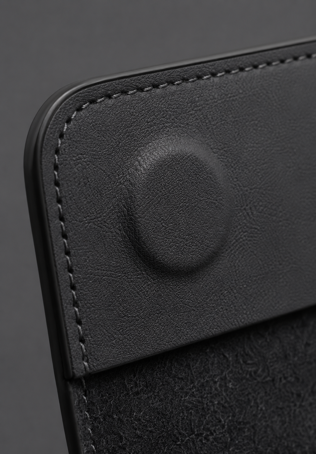 Close-up of the magnetic flap closure on a black Crazy Horse leather MacBook sleeve